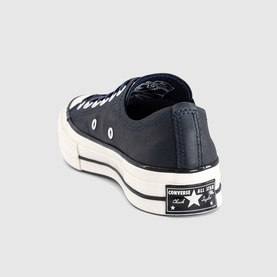 Converse Chuck 70 low-top trainer in navy canvas with cream sole, black lace detail, and signature All Star heel patch
