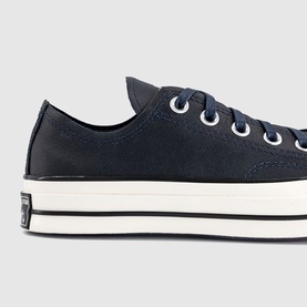 Converse Chuck 70 low-top trainer in navy canvas with white eyelets, black laces, and cream midsole