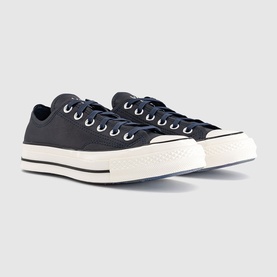 Converse Chuck 70 low-top trainers in dark navy canvas with white lace-up front, black toe cap, and cream midsole