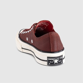 Converse Chuck 70 low-top trainer in smoked paprika, leather upper, black sole, egret midsole, star ankle patch detail.