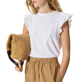 Model wearing Whistles white ruffle sleeve cotton top, styled with khaki wide-leg trousers and carrying a tan woven straw bag