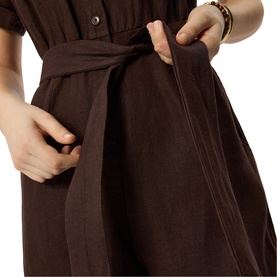 Model wearing Whistles brown dress, close-up of tie waist belt detail and side pocket, short sleeves visible