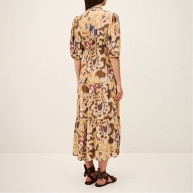 Model wearing Bash yellow ikat-print midi dress with puff sleeves, tiered skirt and shirred waist, styled with brown sandals