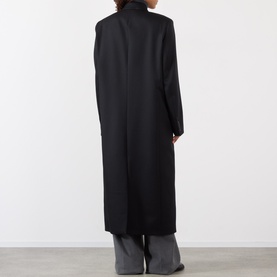 Model wearing Rohe Double-Breasted Tailored Coat in black, back view, with grey wide-leg trousers and ankle boots.