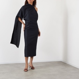 Model wearing Rohe Cape Pencil Dress in Night, featuring asymmetric cape sleeve and midi length, styled with tan heeled mules
