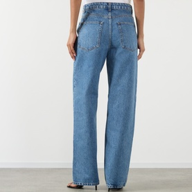 Model wearing Rohe Bruun Straight-Leg Jeans in Heritage Blue, shown from behind, with straight leg, five-pocket styling and tobacco stitching.