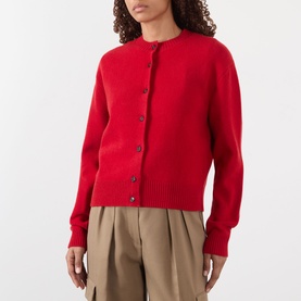 Model wearing Rohe Classic Knit Cardigan in red, round neck, button front, long sleeves, styled with beige wide-leg trousers