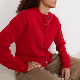 Model wearing Rohe Classic Knit Cardigan in red, round neck, button fastening, felted wool finish, styled with beige trousers