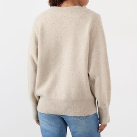 Model wearing Rohe Classic Moulin&eacute; Sweater in Oat Melange, back view, dropped shoulders, ribbed hem, styled with blue jeans.
