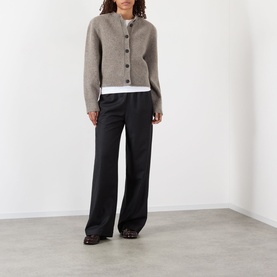 Model wearing Rohe Statement Moulin&eacute; Cardigan in Dark Taupe Melange, oversized with button front and dropped shoulders, styled with black wide-leg