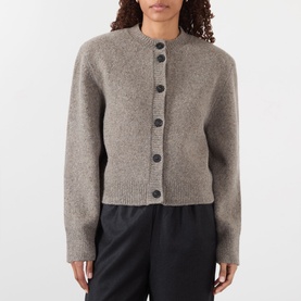 Model wearing Rohe Statement Moulin&eacute; Cardigan in Dark Taupe Melange, round neck, button fastening, styled with black trousers.