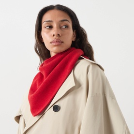 Model with Rohe Triangle Knitted Scarf in red wool, draped around neck, styled with a beige trench coat