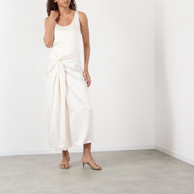 Model wearing Rohe ivory gathered wrap midi skirt with tank top and strappy heeled sandals