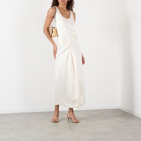 Model wearing Rohe ivory gathered midi skirt, styled with a matching sleeveless top, gold chain shoulder bag and strappy heeled sandals.