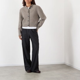 Model wearing Rohe Wide Leg Trousers in Anthracite Melane wool, styled with a grey knit cardigan and white shirt.