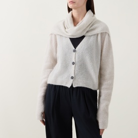 Model wearing Sarah Pacini cream fluffy cardigan with matching scarf wrap, styled with wide-leg dark trousers.