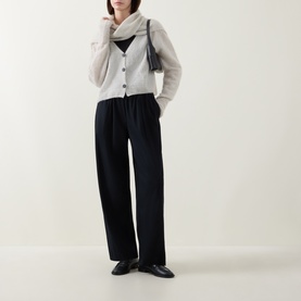 Model wearing Sarah Pacini cream cardigan with black wide-leg trousers, black camisole, and black loafers.