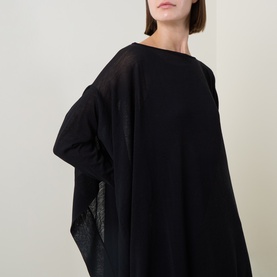 Model wearing Sarah Pacini Knitted Oversized Tunic Dress in black, featuring boat neck and oversized silhouette with long sleeves