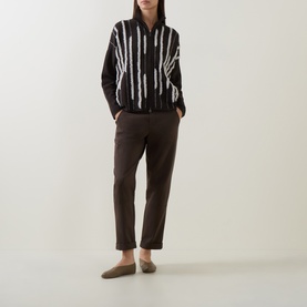 Model wearing Sarah Pacini brown stripe textured jacket with dark brown tapered trousers and tan loafers
