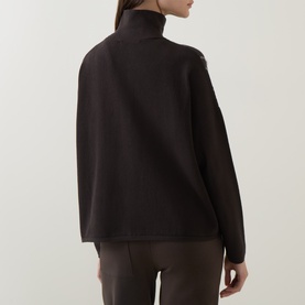Model wearing Sarah Pacini brown high-neck jacket, rear view, styled with brown wide-leg trousers