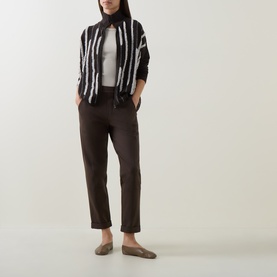 Model wearing Sarah Pacini brown striped jacket with dark brown trousers, grey top, and taupe loafers