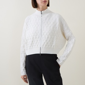 Model wearing Sarah Pacini Honeycomb Knit Zip Cardigan in white, styled with black wide-leg trousers