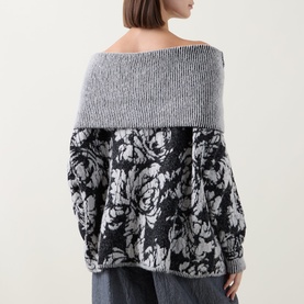 Model wearing Sarah Pacini black floral jacquard knit sweater with contrast grey ribbed yoke, balloon sleeves, back view