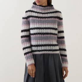 Model wearing Sarah Pacini mohair striped rollneck jumper in pink, white and black stripes, paired with a dark midi skirt.