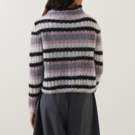 Model wearing Sarah Pacini mohair striped knitwear, back view, black and pastel pink horizontal stripes, mock neck, long sleeves