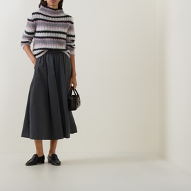 Model wearing Sarah Pacini striped mohair jumper in lilac and grey, styled with dark midi skirt, black loafers and mini bag.