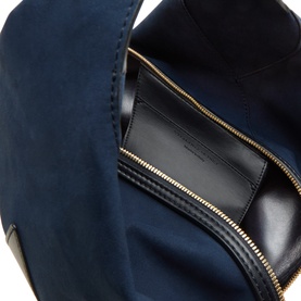 Stella McCartney Appaloosa Bucket Bag in navy, interior view showing black faux leather lining, card slot, and gold-tone zip fastening