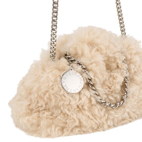 Stella McCartney cream fluffy crossbody bag with silver chain strap and circular logo charm, textured shearling-style exterior