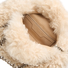 Stella McCartney cream faux shearling crossbody bag, open top view showing beige interior pocket and silver chain strap detail