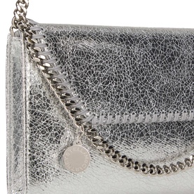 Stella McCartney silver metallic crossbody bag with silver chain trim and logo charm, close-up detail shot