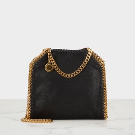 Stella McCartney Falabella mini crossbody bag in black with gold chain straps, woven trim detail, and branded coin charm.