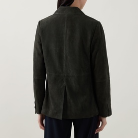 Model wearing Vince olive suede jacket, rear view showing centre back vent and button cuffs, styled with dark trousers