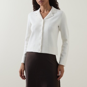 Model wearing Vince off white wool cashmere blend knit cardigan with collar and button front, styled with brown satin midi skirt