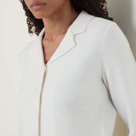 Model wearing Vince off white wool cashmere knitwear with notched lapel collar, close-up detail shot