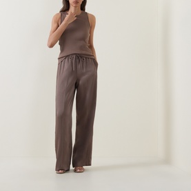 Model wearing Vince brown cashmere-silk sleeveless top, styled with wide-leg trousers and heeled sandals in matching brown tones.