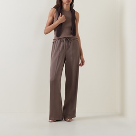 Model wearing Vince brown cashmere-silk sleeveless top with matching wide-leg trousers and strappy heeled sandals.