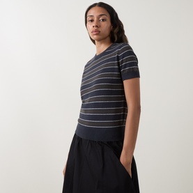 Model wearing Vince T-Shirt in Thyme Combo, short-sleeve striped knit style, styled with black wide-leg trousers.