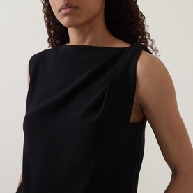 Model wearing Vince Draped Tank Top in black with asymmetric neckline, gathered drape detail, and sleeveless design.