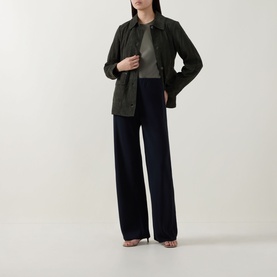 Model wearing Vince navy wide-leg trousers in acetate blend, styled with a dark green shirt jacket and grey top, heeled sandals.