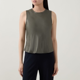 Model wearing Vince sleeveless top in Pine Grove, relaxed cropped silhouette with crew neck, styled with dark trousers