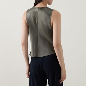 Model wearing Vince sleeveless satin top in Pine Grove, rear view showing centre back seam detail, styled with navy wide-leg trousers
