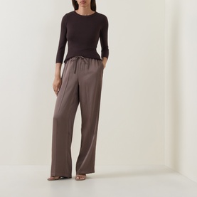 Model wearing Vince Taupe Haze cotton top with three-quarter sleeves, styled with wide-leg trousers and strappy heels.