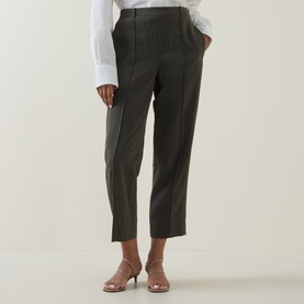 Model wearing Vince sea vine tapered trousers with front seam detail, styled with a white shirt and nude heeled mules