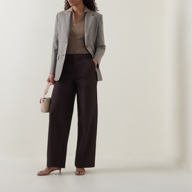 Model wearing Vince Pleated Straight-Leg Trousers in brown with grey blazer, beige top, and nude heels, carrying small cream bag.