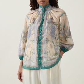 Model wearing Zimmermann Indra Billow Scarf Floral Blouse in Cream Scarf Floral with teal trim, bead edge, and enamel buttons, styled with white