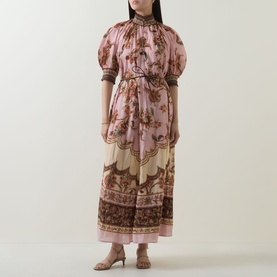 Model wearing Zimmermann Mauve Jacobean dress with puff sleeves, high neck, floral print, and belted waist, styled with strappy sandals.
